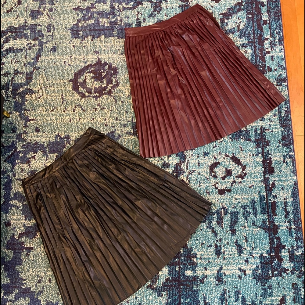 Pair of faux leather pleated skirts